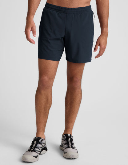 Navy Pivotal 2.0 Men's Lined Short 7" with an elastic waistband and relaxed fit shown on a standing model.