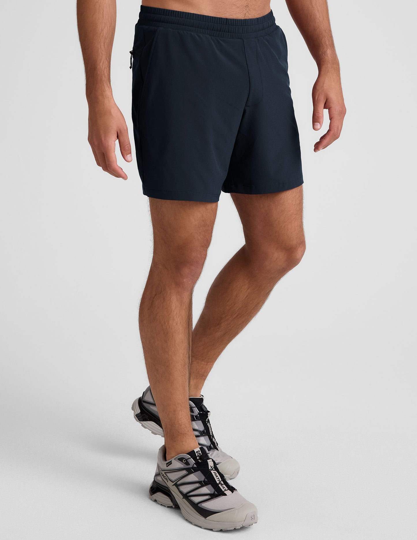 Navy Pivotal 2.0 Men's Lined Short 7 inch on a model, featuring an elastic waistband and relaxed fit in a side profile.