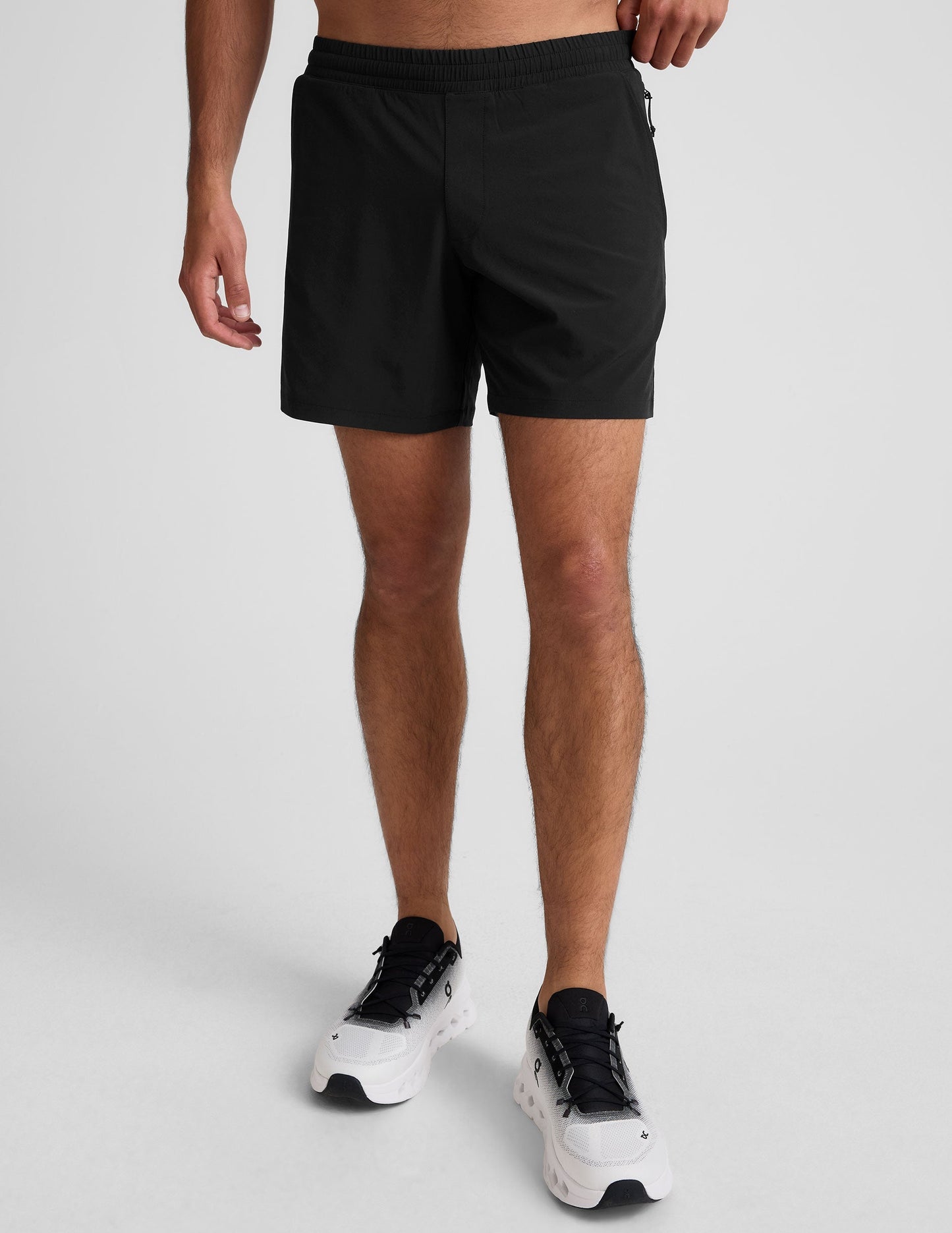 Front view of a person wearing black Pivotal 2.0 Men's Lined Shorts with an elastic waistband and mid-thigh length.