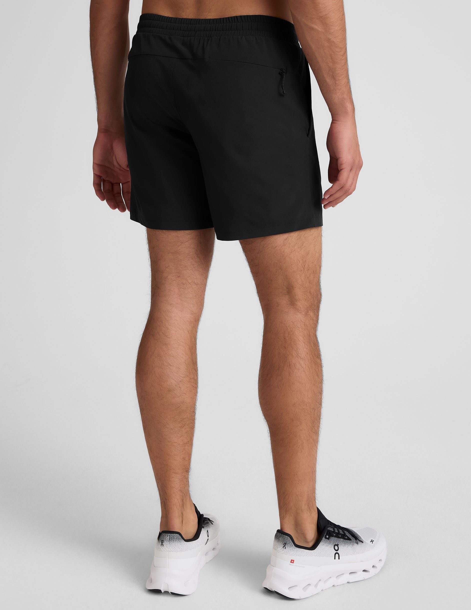 Back view of black Pivotal 2.0 Men's Lined Short 7" featuring an elastic waistband and an invisible rear zipper pocket.