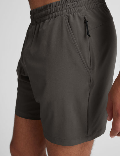 Side view of Pivotal 2.0 Men's Short in dark gray featuring an elastic waistband, side pocket, and a hidden zipper pocket.