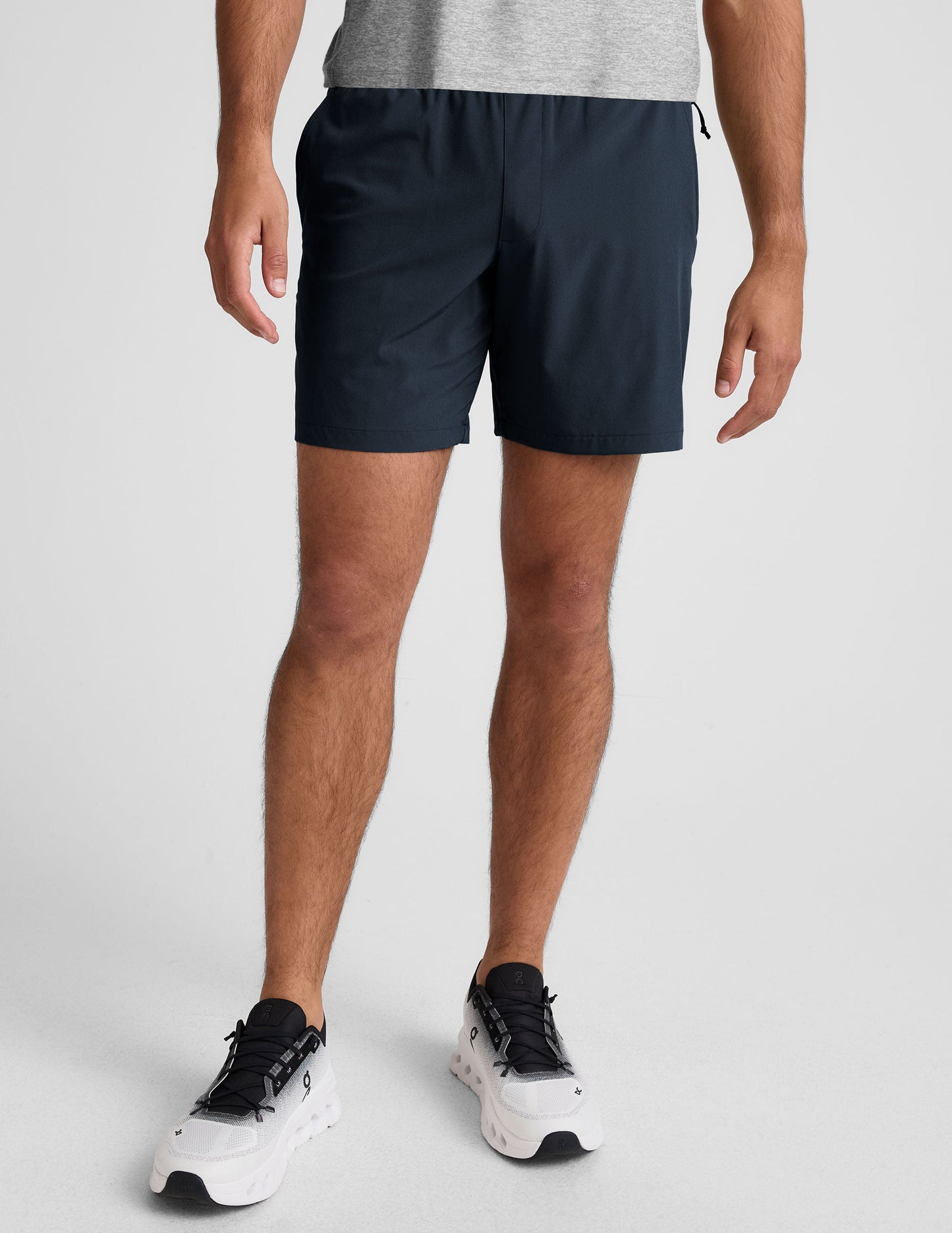Navy blue Pivotal 2.0 Men's Short 7" with an elastic waistband and relaxed fit, hitting at mid-thigh on a model.
