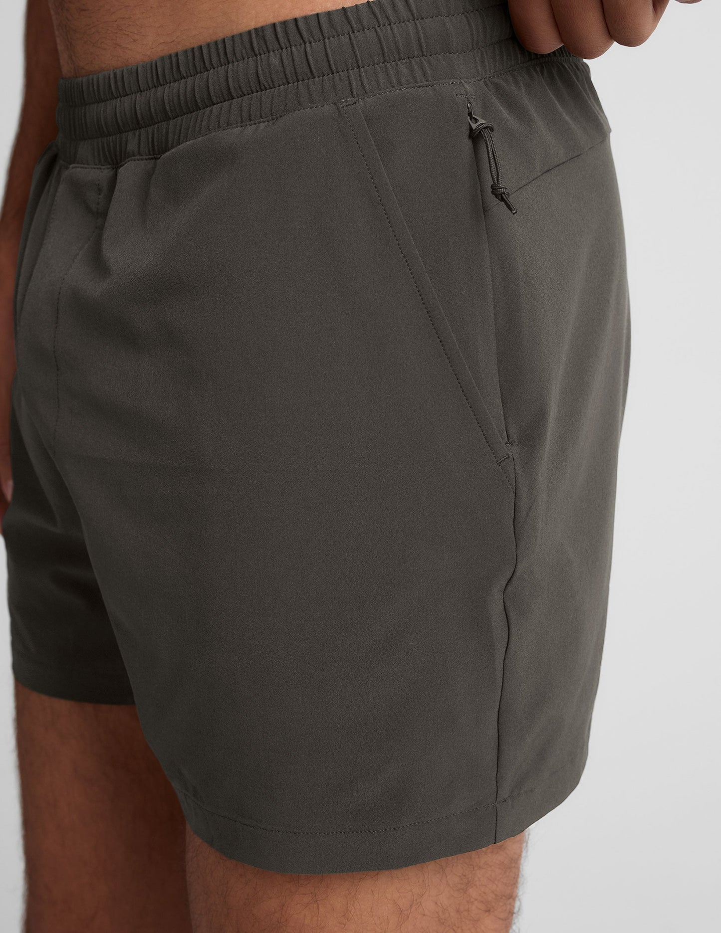 Side view of the gray Pivotal 2.0 Men's Lined Short 5" showing the elastic waistband and zippered side pocket detail.