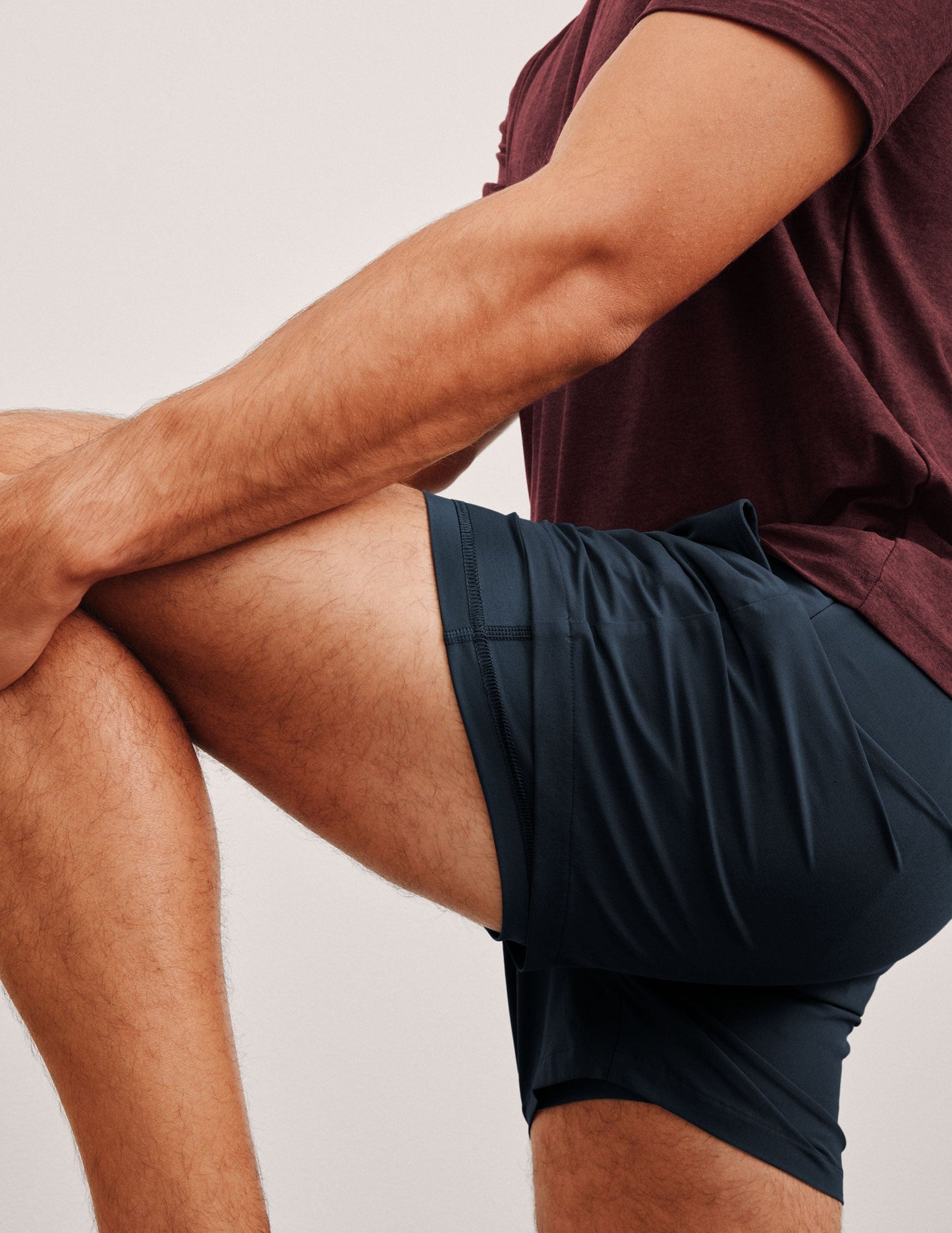 navy t-shirt and navy 5" shorts on a plain background.