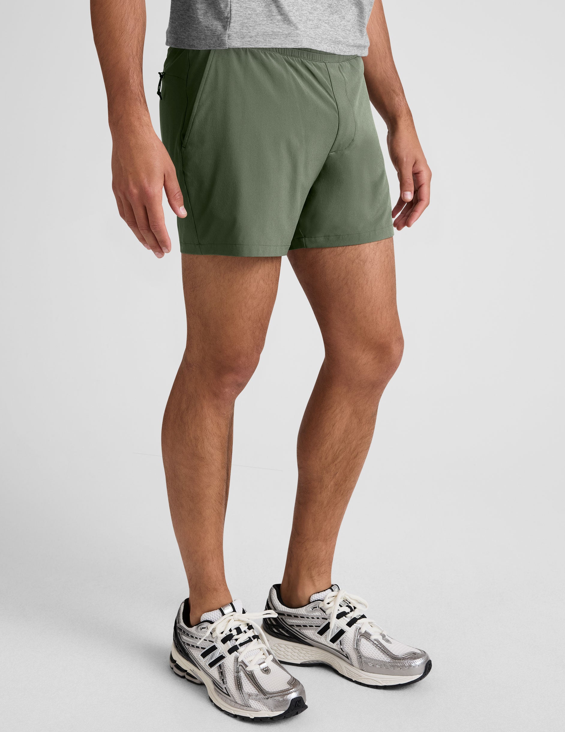 Pivotal 2.0 Men's Lined Short 5" in olive green with an elastic waistband and pockets, shown on a model from the side.