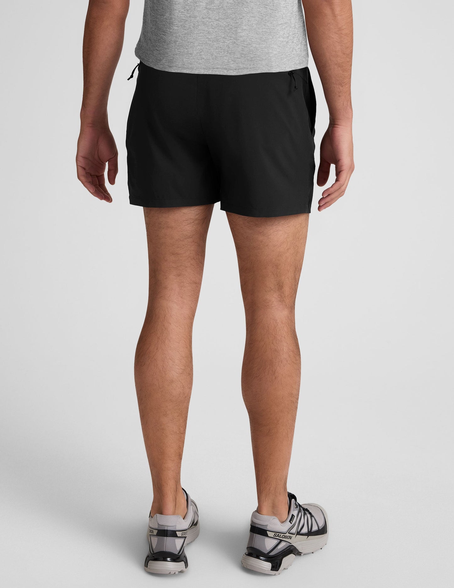 Rear view of the black Pivotal 2.0 Men's Lined Short 5" featuring an elastic waistband and back zippered pockets.