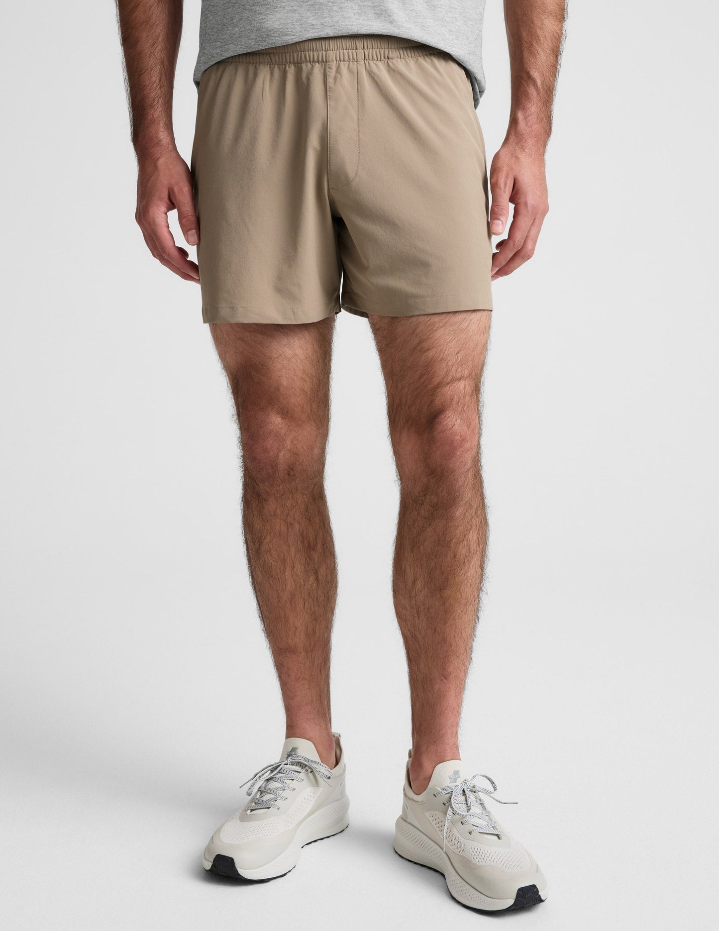 Front view of Pivotal 2.0 Men's Short 5" in beige, featuring a relaxed mid-thigh fit and a gathered elastic waistband.