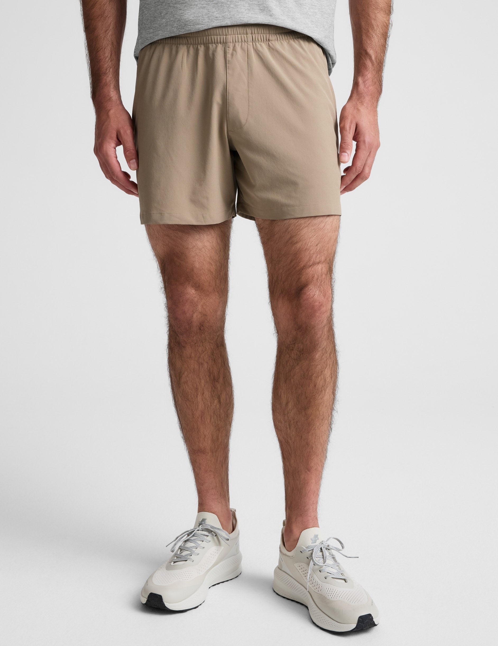 Front view of Pivotal 2.0 Men's Short 5" in beige, featuring a relaxed mid-thigh fit and a gathered elastic waistband.