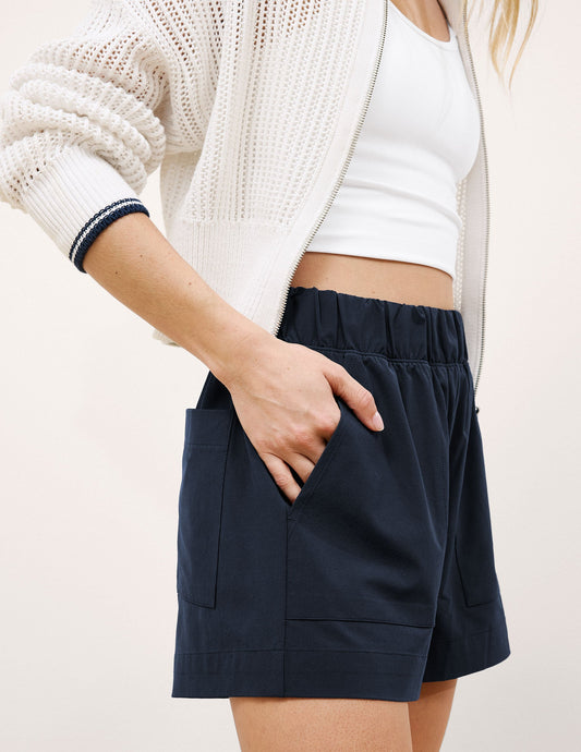 Mid-rise navy Easy 3" Short with a gathered elastic waistband and side pockets, shown on a model with hand in pocket.