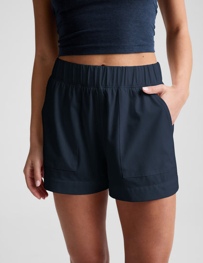 Mid-rise navy Easy 3" Short with a gathered elastic waistband and side pockets, shown on a model from the waist down.
