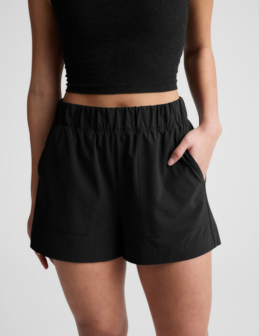 Front view of black Easy 3" Short featuring a gathered elastic waistband and side seam pockets on a model.