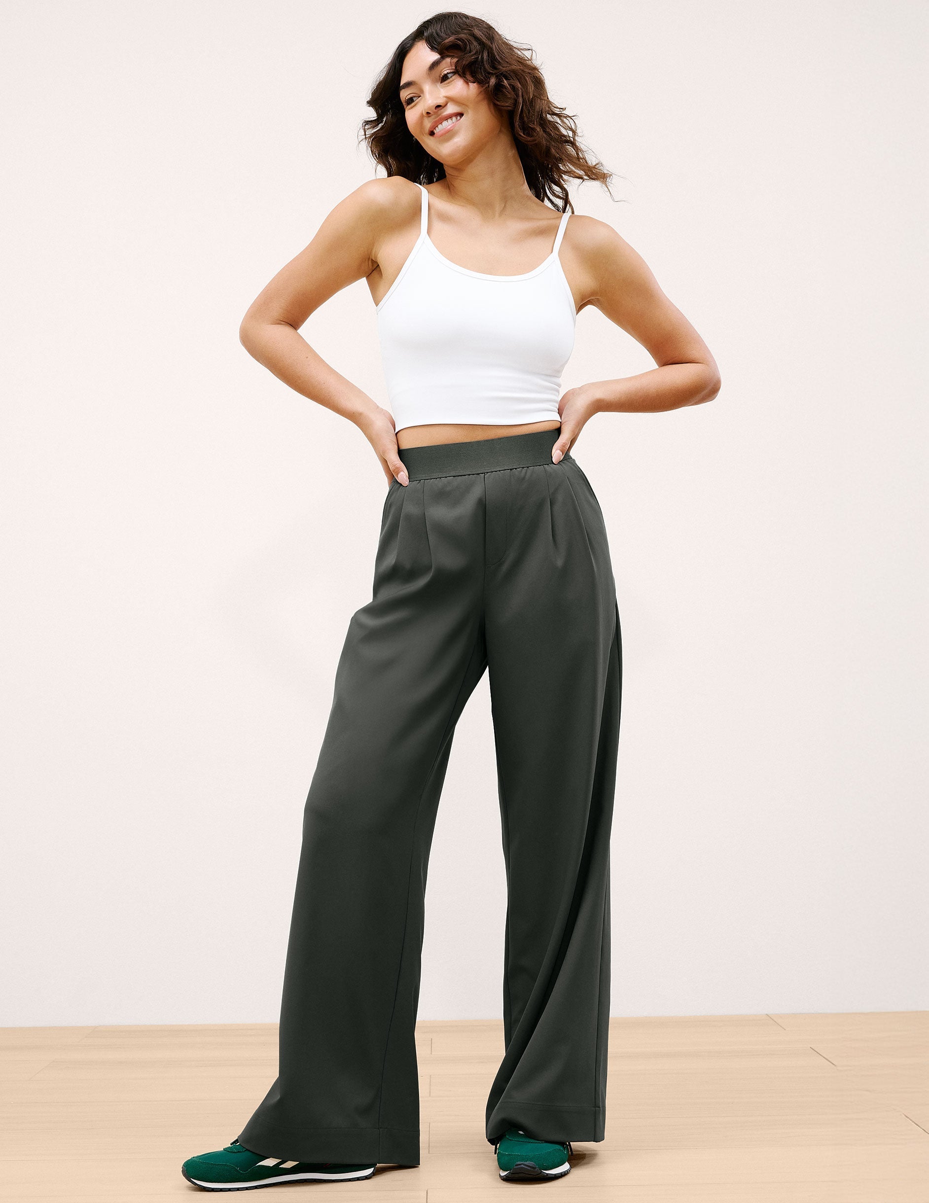 Woman in dark green Elasticated Trouser Pant 31" featuring a wide leg, front pleats, and an elasticated waistband.