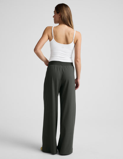 Rear view of a model wearing dark green wide-leg Elasticated Trouser Pant 31" with a comfortable elastic waistband.