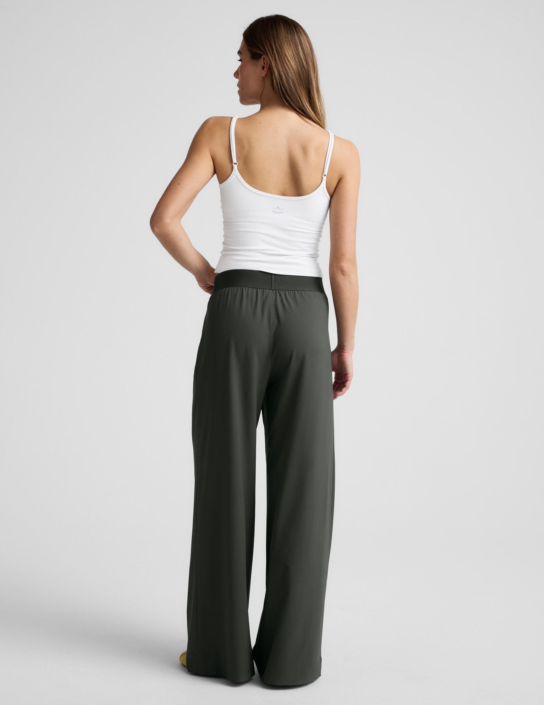 Rear view of a model wearing dark green wide-leg Elasticated Trouser Pant 31" with a comfortable elastic waistband.