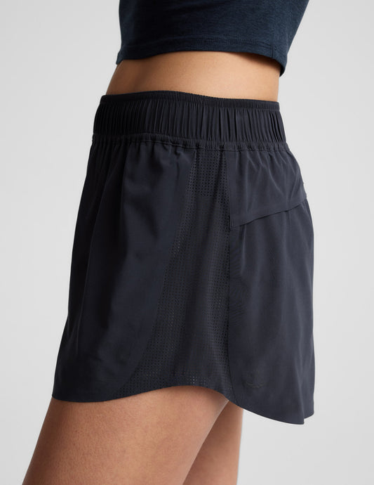 Side profile of navy Solemate 2.5" Short showing the gathered elastic waistband and perforated mesh side panels.