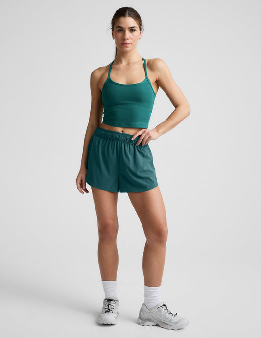 Woman wearing Teal Solemate™ 2.5" Short with a gathered waistband, paired with a teal crop top and white sneakers.