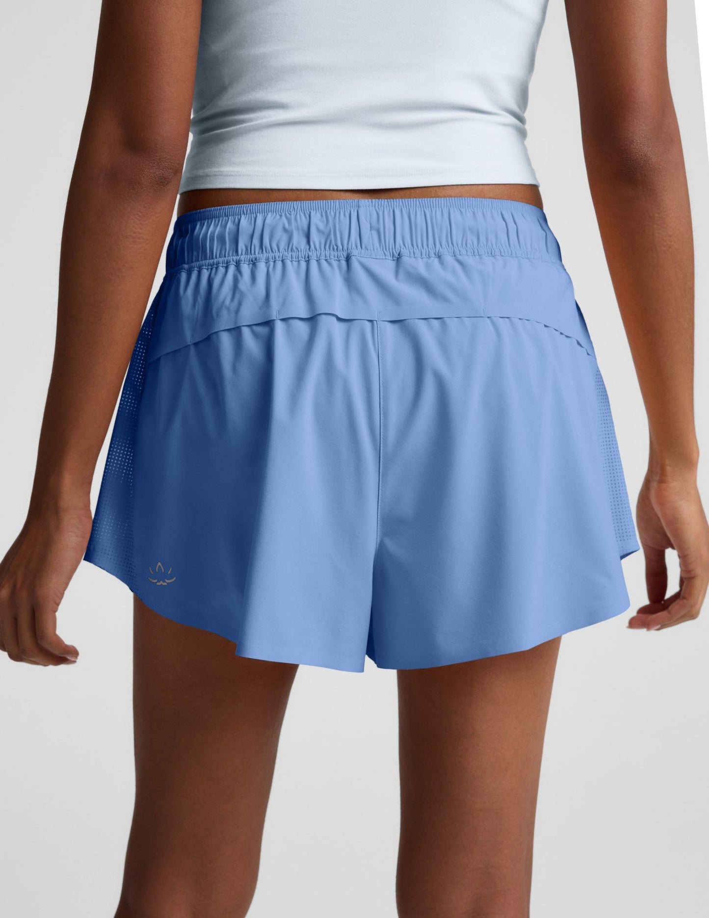 Back view of the blue Solemate 2.5" Short with a gathered elastic waist, vented back, and breathable perforated side panels.