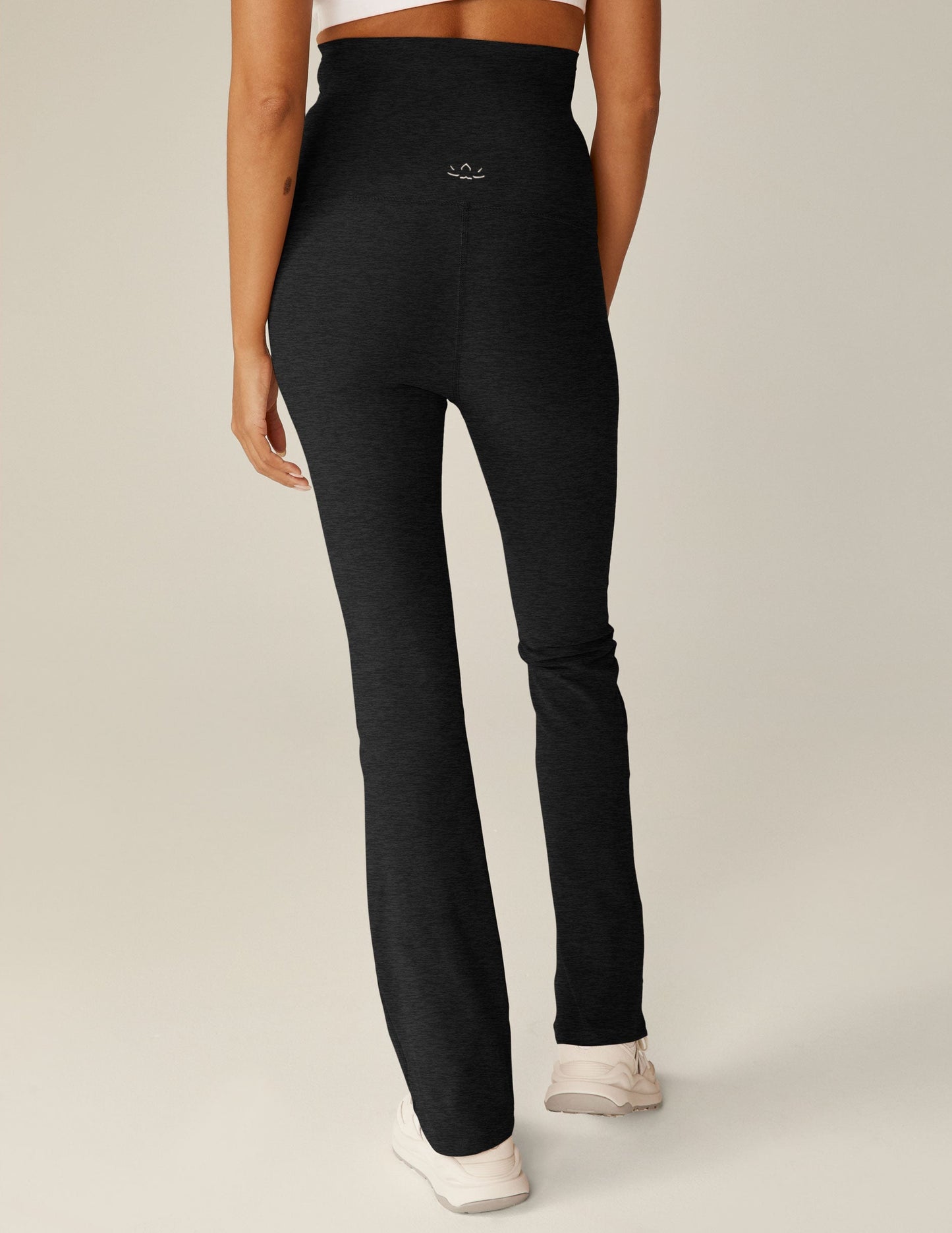 Back view of black Spacedye Practice Maternity Pant in marled fabric with a high waistband and flared bootcut legs.