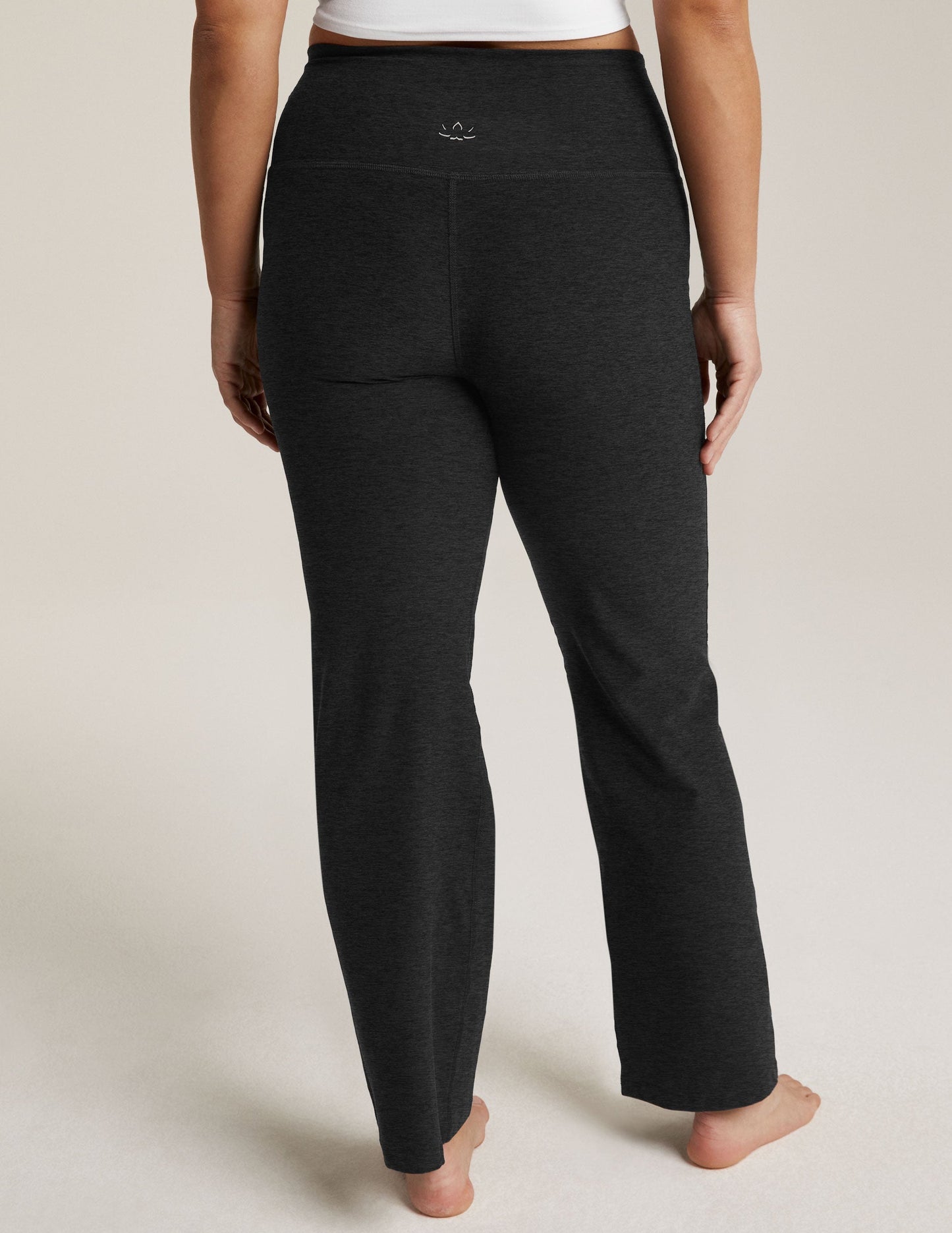 Back view of marled black Spacedye Practice High Waisted Pant with a wide high-rise waistband and flared bootcut leg.