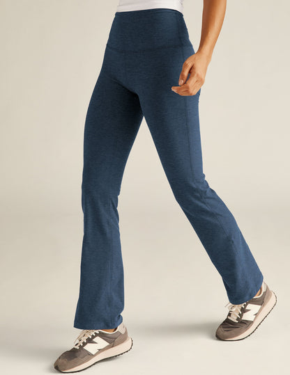 Nocturnal Navy Spacedye Practice High Waisted Pant with a marled texture and bootcut leg on a person walking.