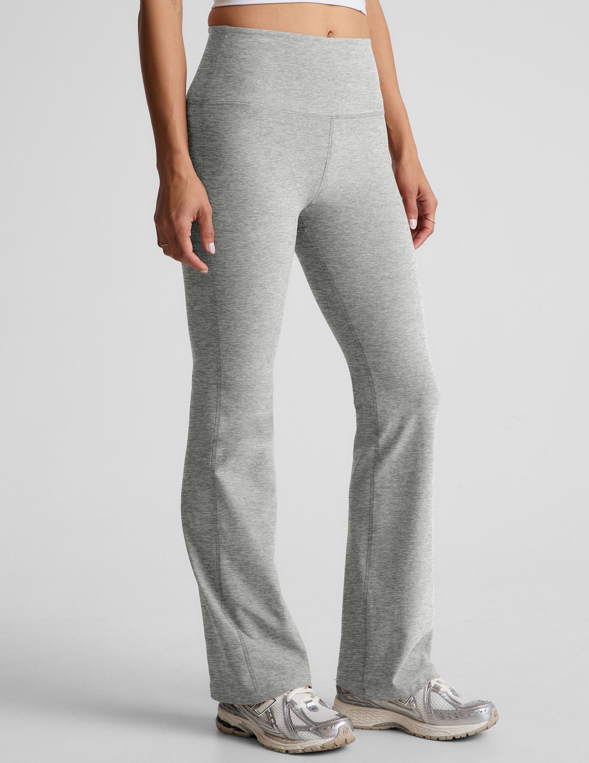 Light gray marled Spacedye Practice High Waisted Bootcut Pant featuring a wide waistband and flared hem, shown on a model.