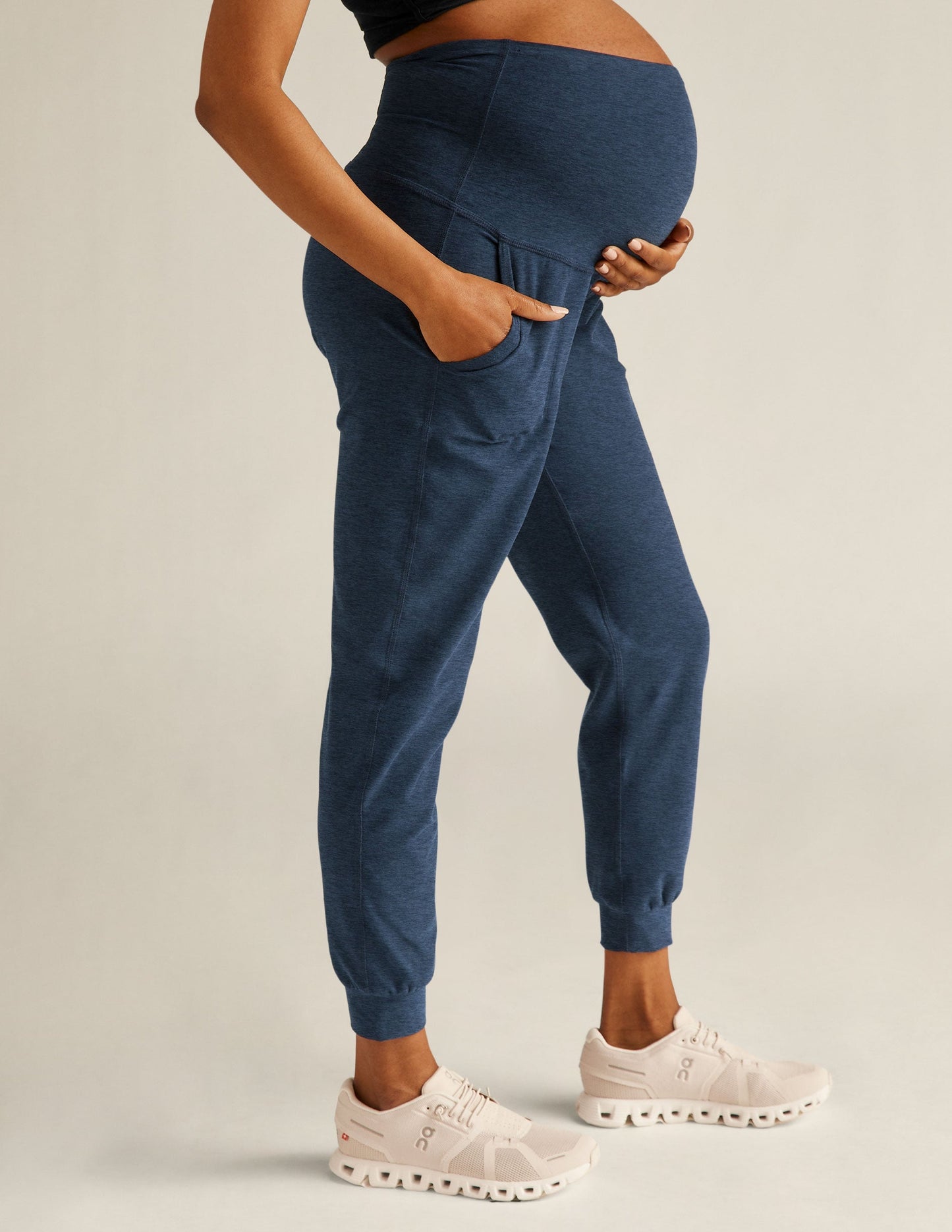 Navy marled Spacedye Beyond the Bump Maternity Midi Jogger on a pregnant model with high waist, side pockets, and cuffs.