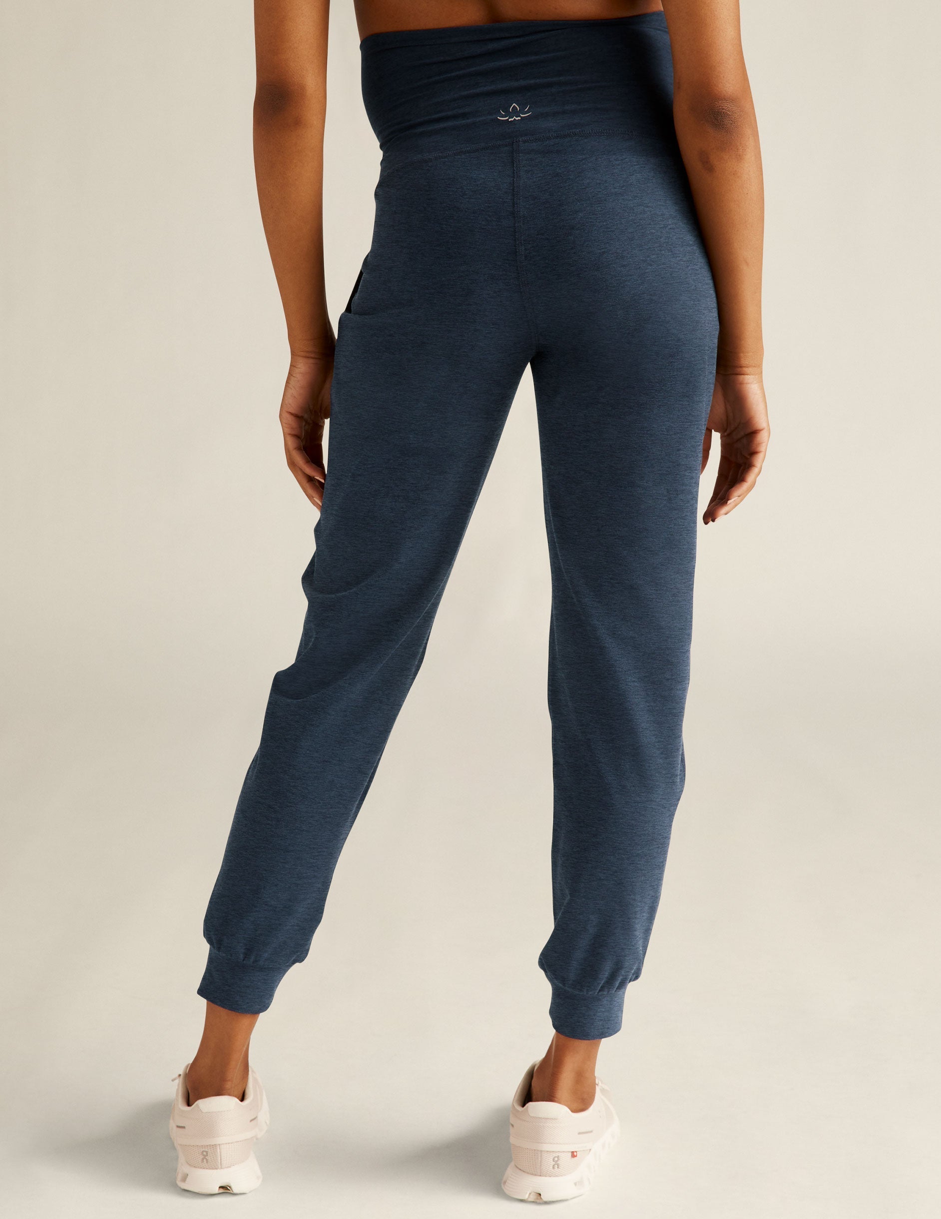 Rear view of navy Spacedye Beyond the Bump Maternity Midi Jogger featuring a high waist and slim tapered legs with cuffs.