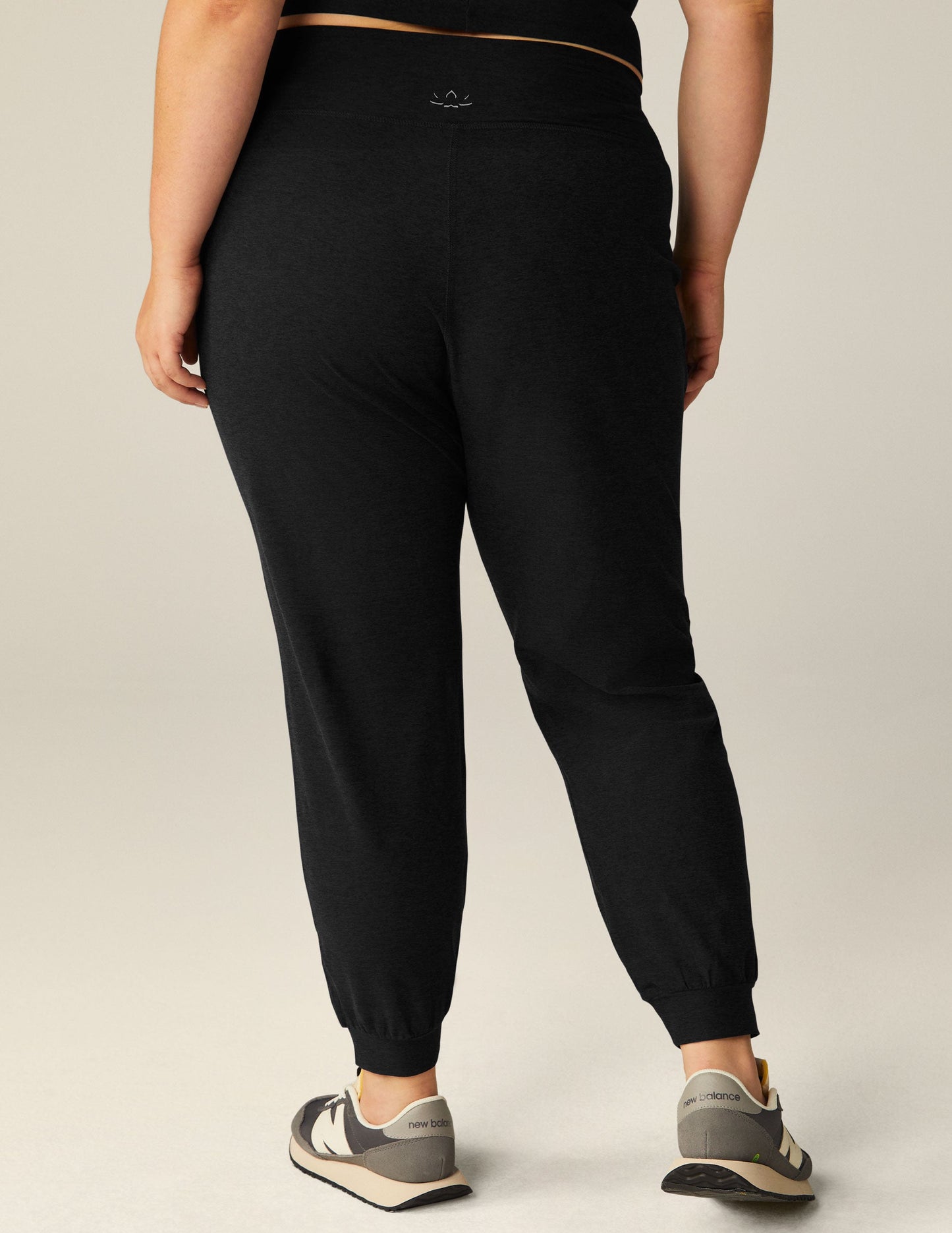 Rear view of the black Spacedye Midi Jogger featuring a wide waistband and tapered legs with banded cuffs.