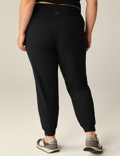 Rear view of the black Spacedye Midi Jogger featuring a wide waistband and tapered legs with banded cuffs.