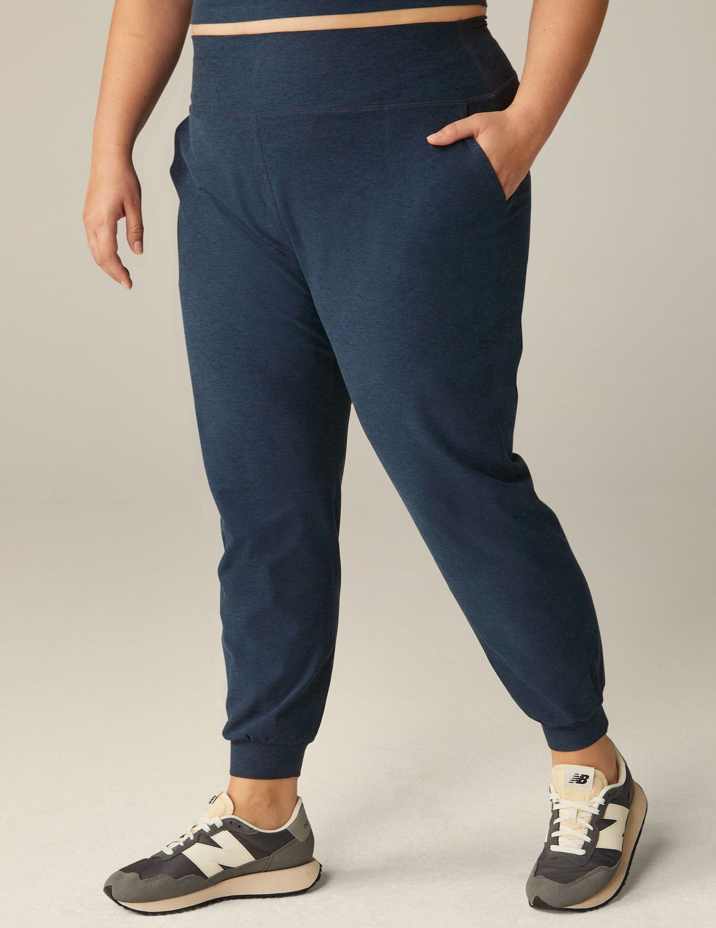 Spacedye Midi Jogger in Nocturnal Navy, featuring a high elastic waistband, side pockets, and tapered cuffs with sneakers.