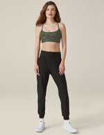 Woman wearing the Spacedye Midi Jogger in marled black featuring a wide waistband and tapered legs with banded cuffs.