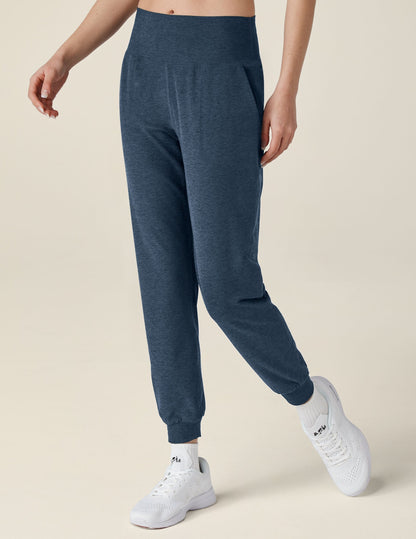 Woman wearing navy marled Spacedye Midi Jogger with a wide waistband and tapered ankles, paired with white athletic shoes.