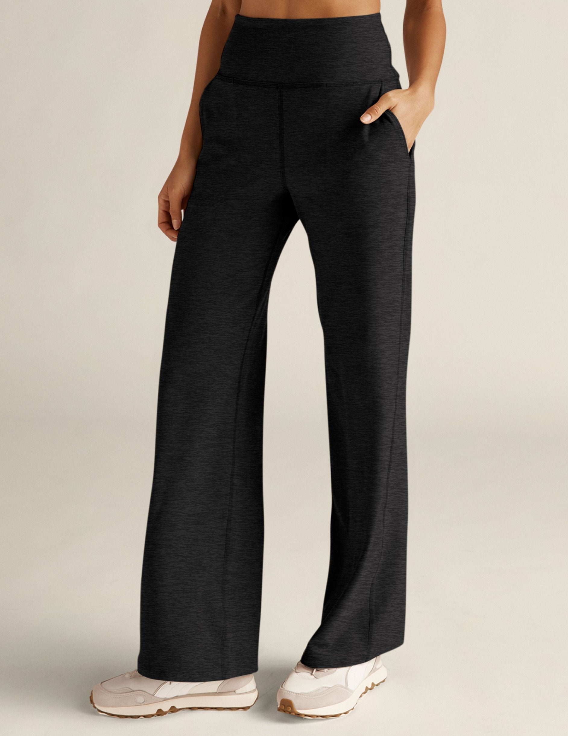 Woman wears black marled Spacedye Laid Back Pant featuring a high waistband, wide legs, and side pockets.