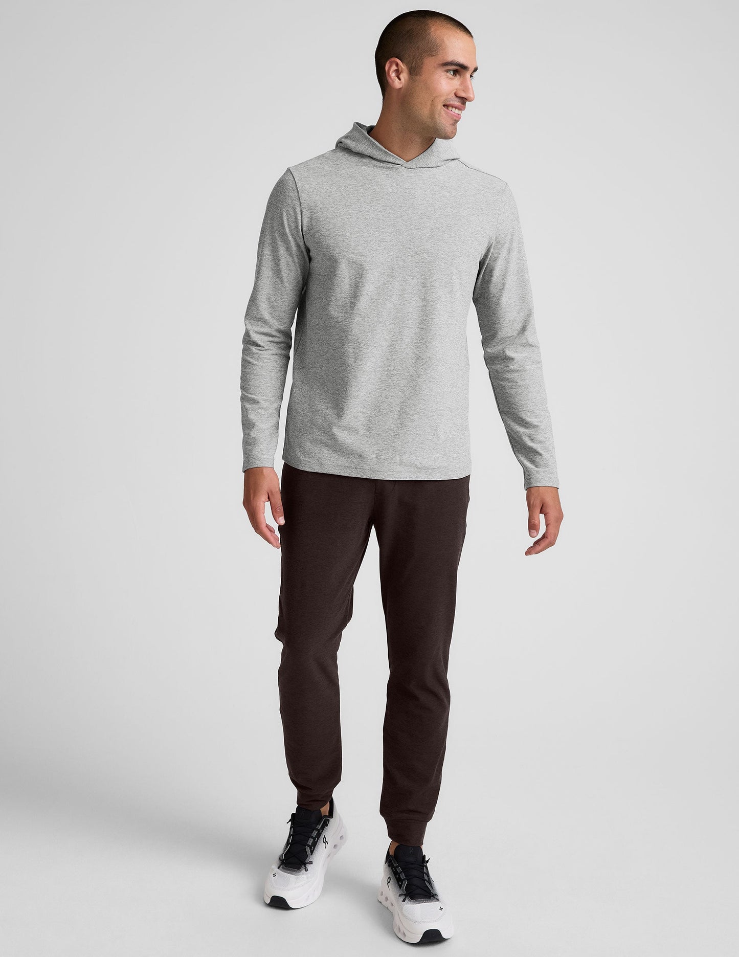 Man wearing slim-fit, dark Spacedye Freefit Men's Zipper Pockets Jogger with banded cuffs and elastic waistband.
