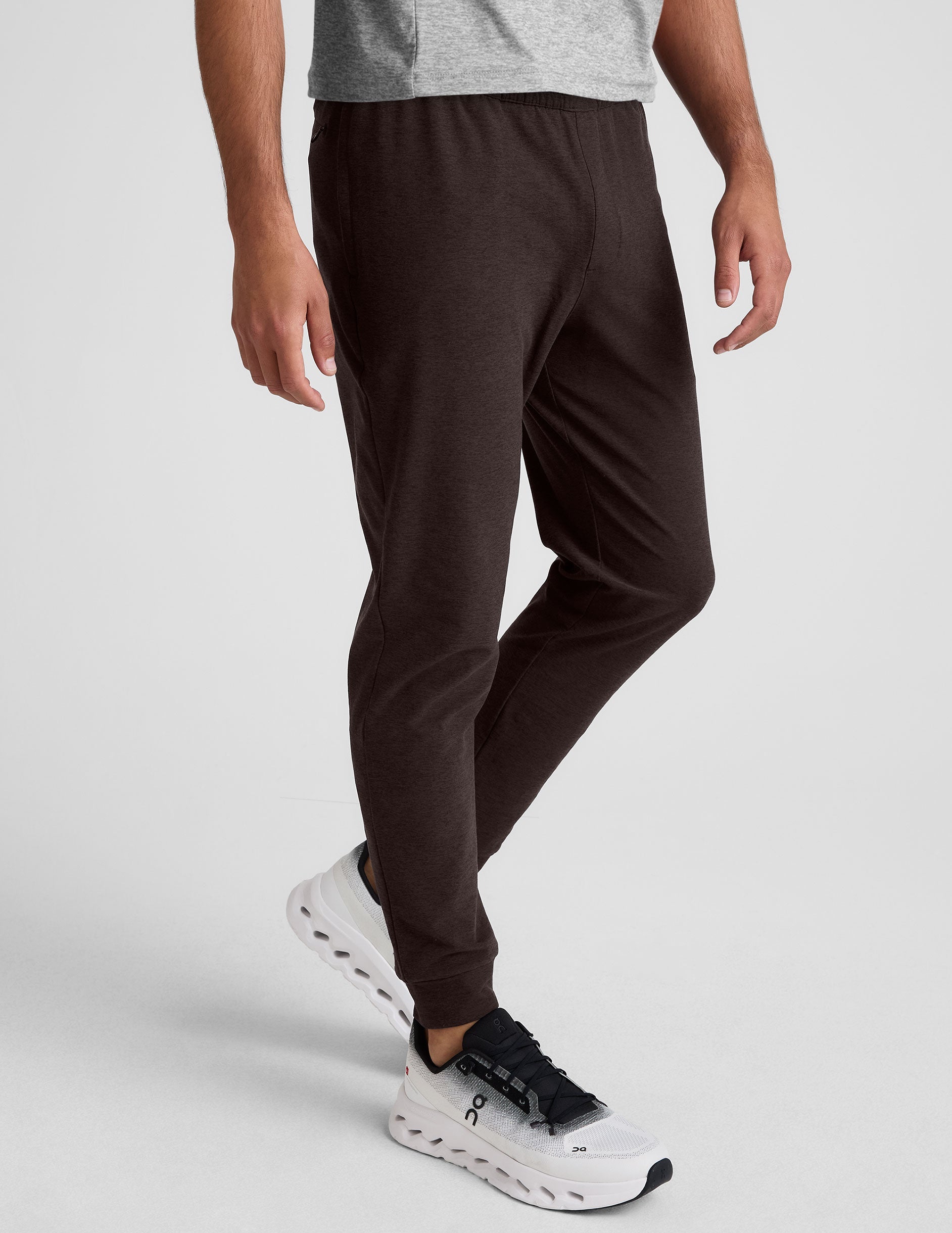 Slim-fit marled gray Spacedye Freefit Men's Zipper Pockets Jogger with an elastic waist and cuffed hems on a walking model.