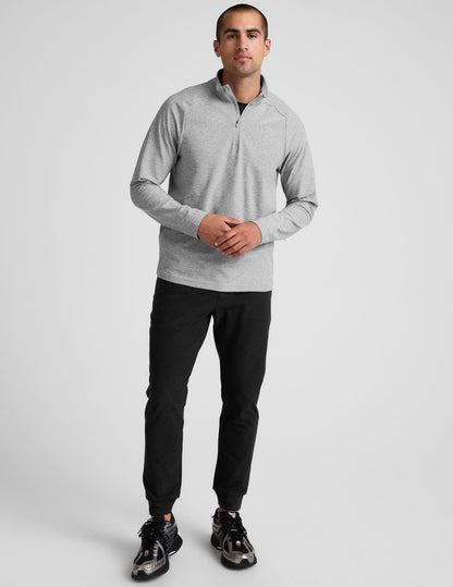 Man modeling the black slim-fit Spacedye Freefit Men's Zipper Pockets Jogger with banded cuffs and zipper side pockets.