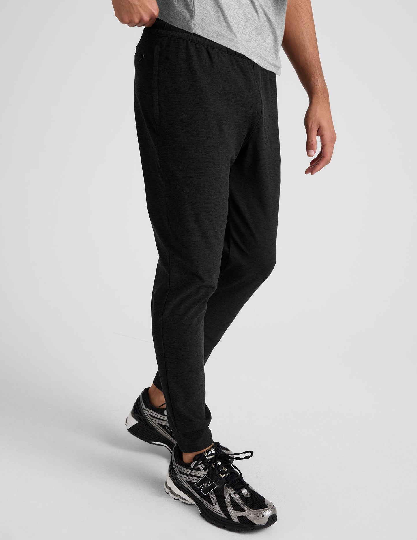 Side view of Spacedye Freefit Men's Zipper Pockets Jogger in black with a slim fit, elastic waist, and banded ankle cuffs.
