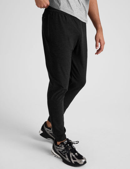 Side view of Spacedye Freefit Men's Zipper Pockets Jogger in black with a slim fit, elastic waist, and banded ankle cuffs.