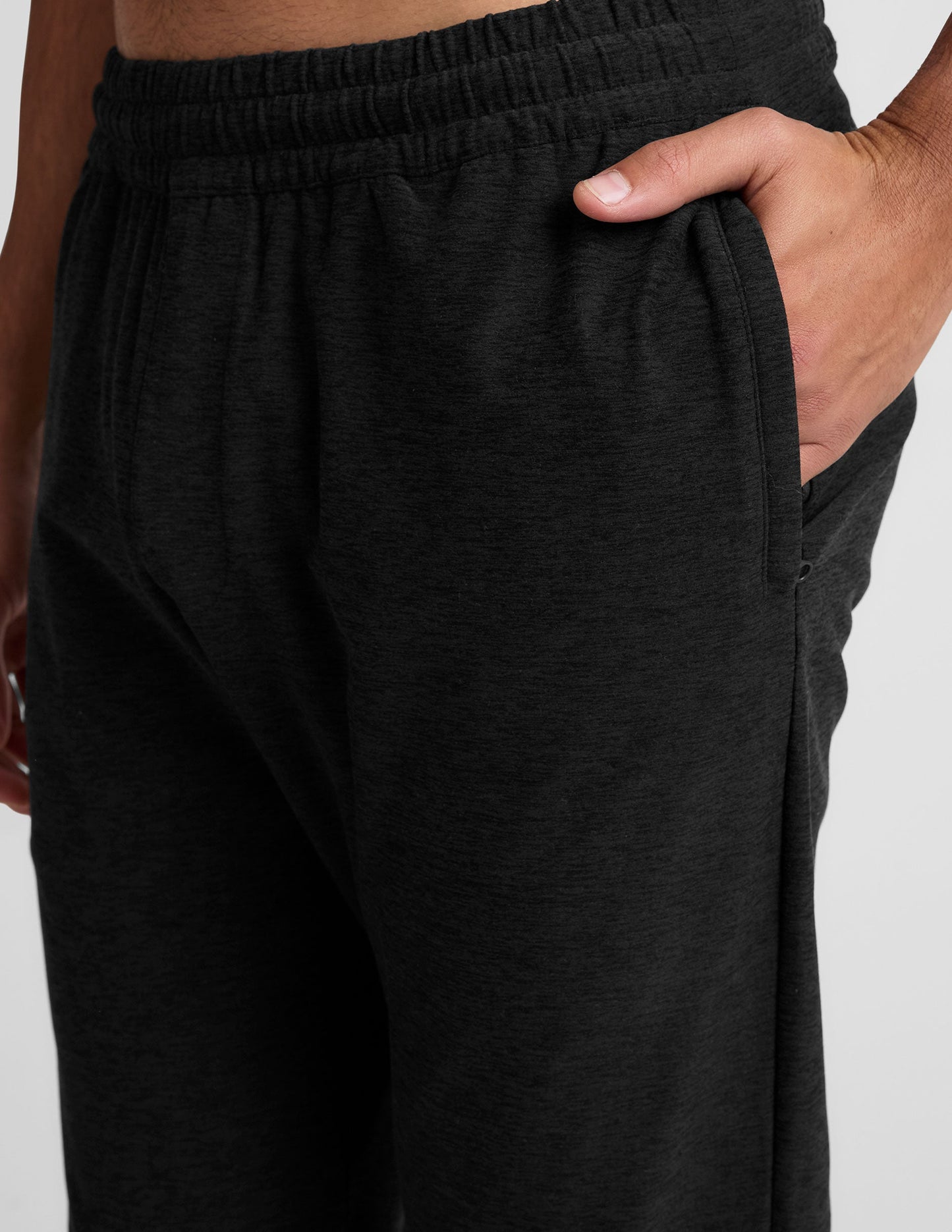 Close-up of the Spacedye Freefit Men's Zipper Pockets Jogger in black, showing the elastic waistband and side zipper pocket.