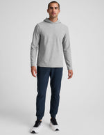 Man wearing dark marled Spacedye Freefit Men's Zipper Pockets Jogger with a slim fit, elastic waist, and banded ankle cuffs.