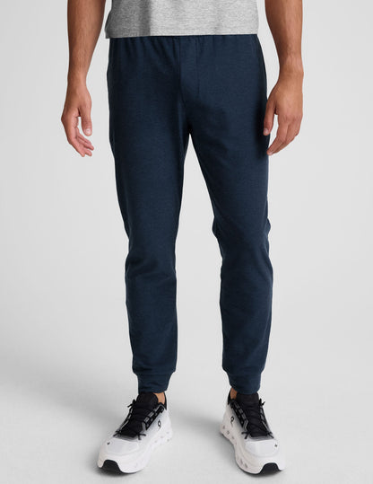 Spacedye Freefit Men's Zipper Pockets Jogger in navy marled fabric with a slim fit and banded cuffs on a model.