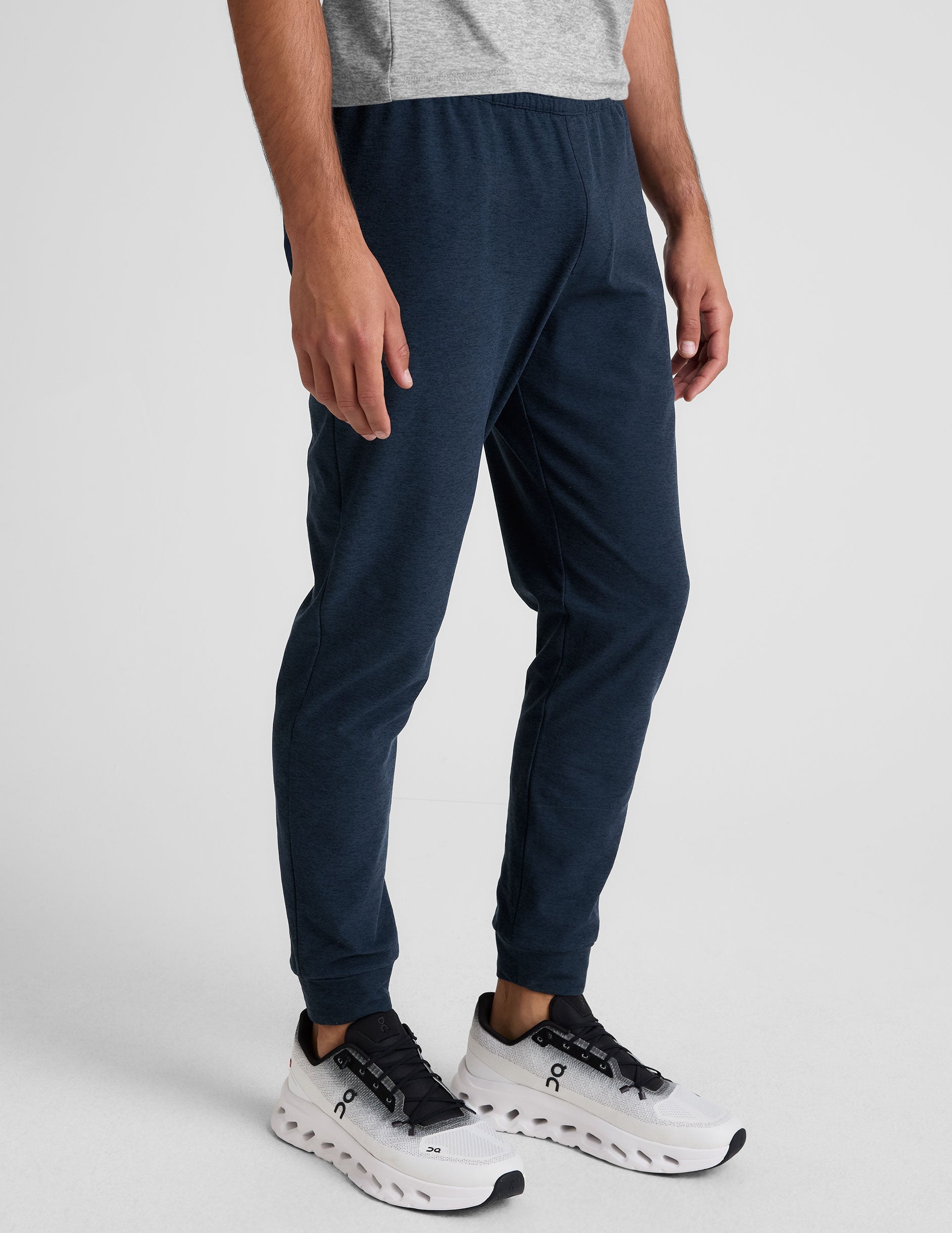 Slim-fit navy marl Spacedye Freefit Men's Zipper Pockets Jogger with elastic waist and cuffed ankles shown on a model.