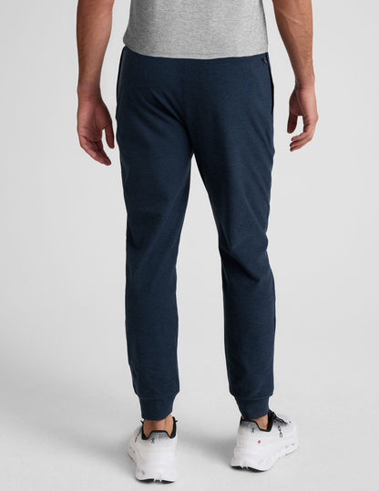 Rear view of slim-fit Spacedye Freefit Men's Zipper Pockets Jogger in navy marled fabric with banded cuffs.