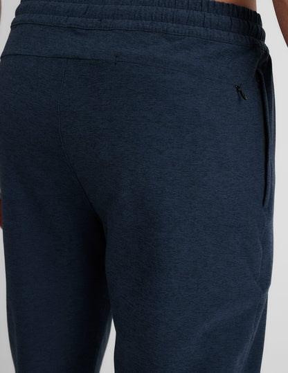 Close-up of Spacedye Freefit Men's Zipper Pockets Jogger in marled dark blue with elastic waistband and side zipper pocket.