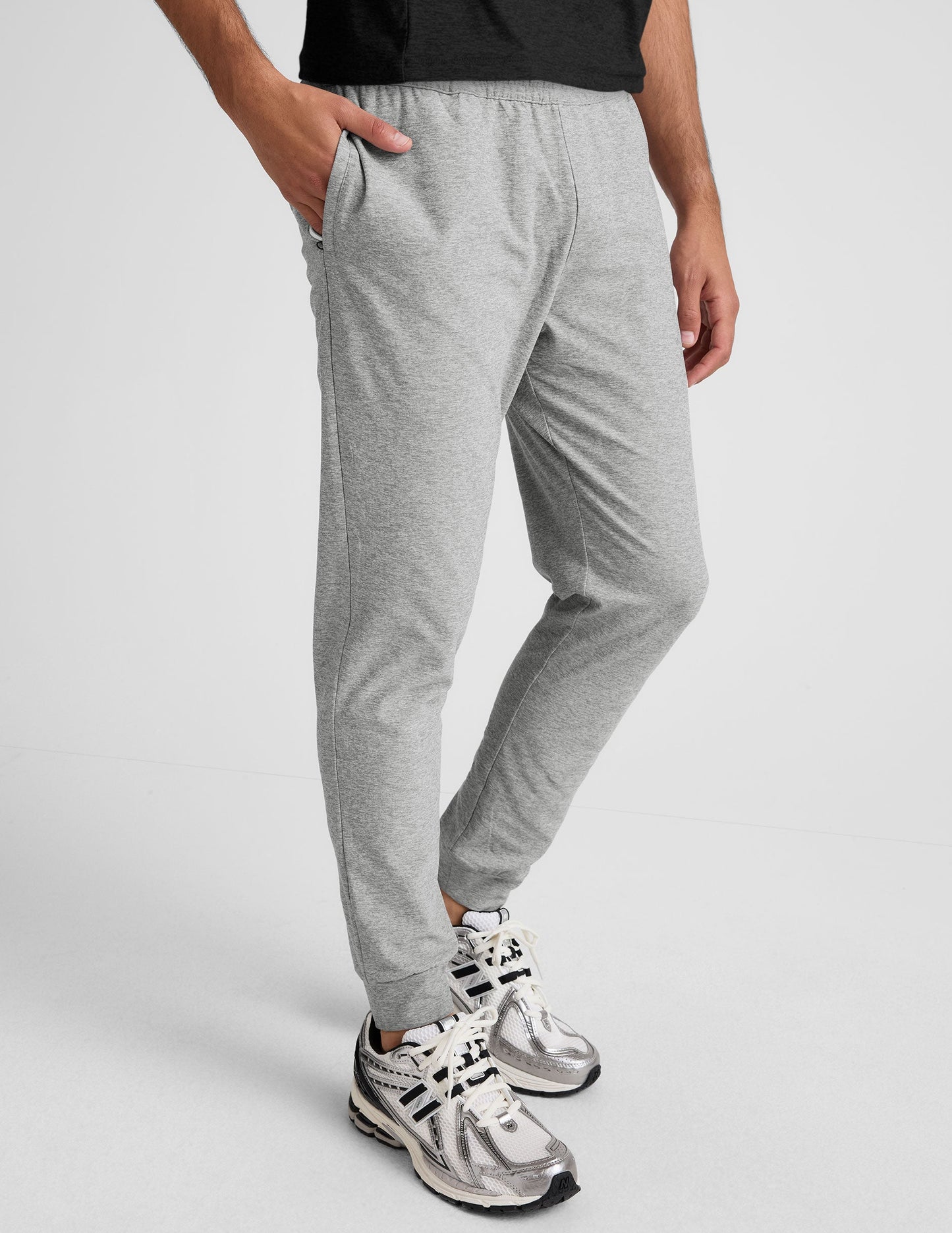 Light grey marled Spacedye Freefit Men's Zipper Pockets Jogger with a slim fit, elastic waist, and zippered side pockets.