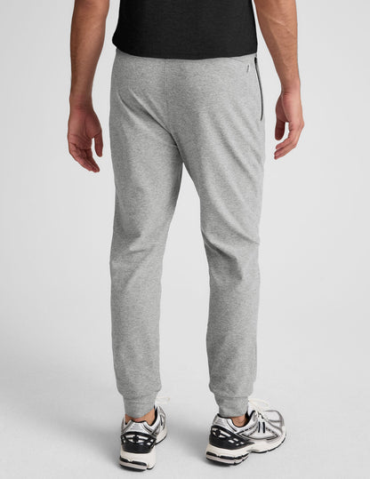 Back view of light grey marled Spacedye Freefit Men's Zipper Pockets Jogger with a slim fit and banded ankle cuffs.