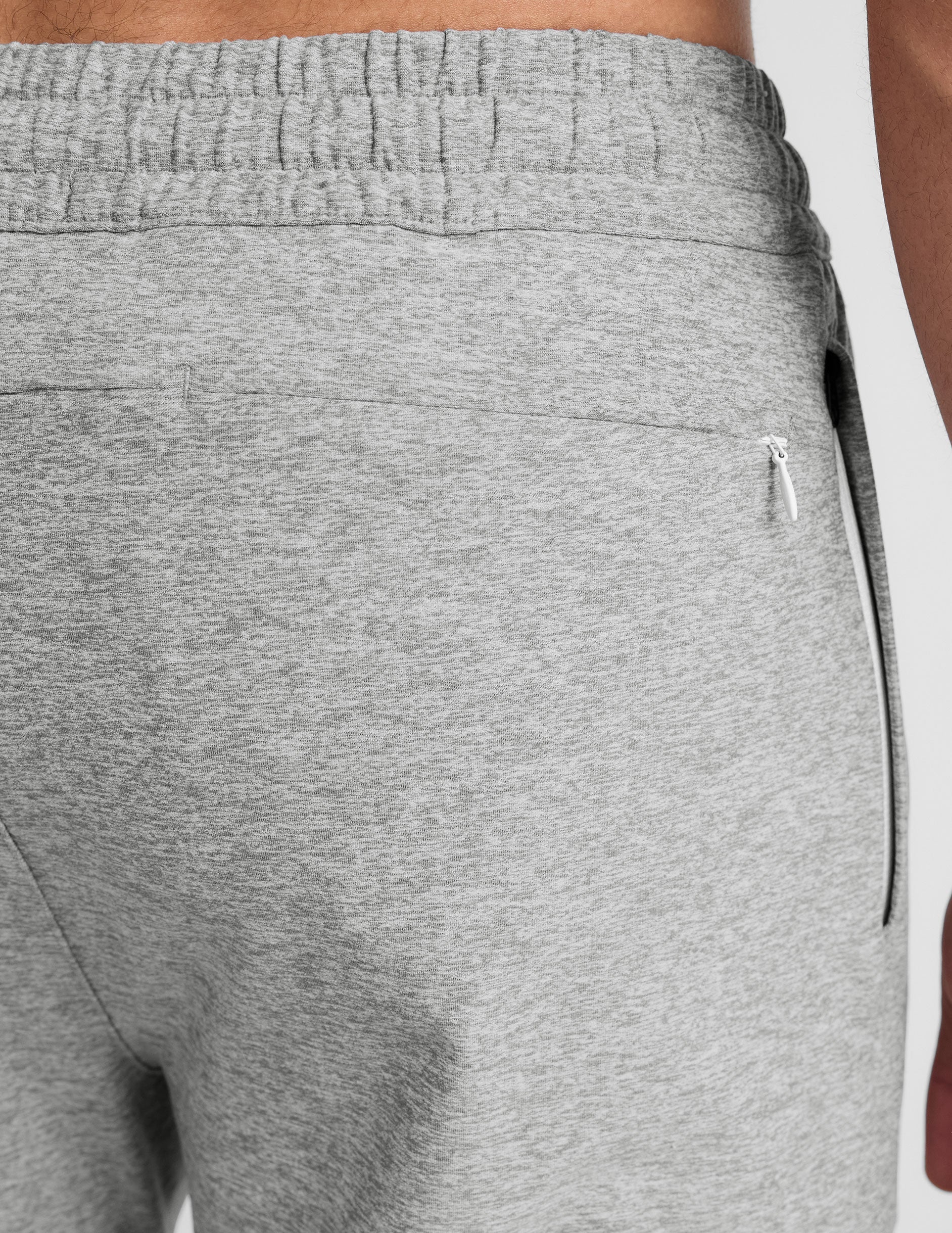 Close-up of Spacedye Freefit Men's Zipper Pockets Jogger in marled grey featuring an elastic waistband and zippered pocket.