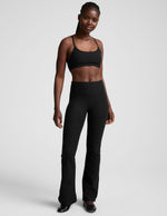 Black Spacedye Mid-Rise Bootcut Pant on a model, featuring a snug fit, wide waistband, and flared leg.