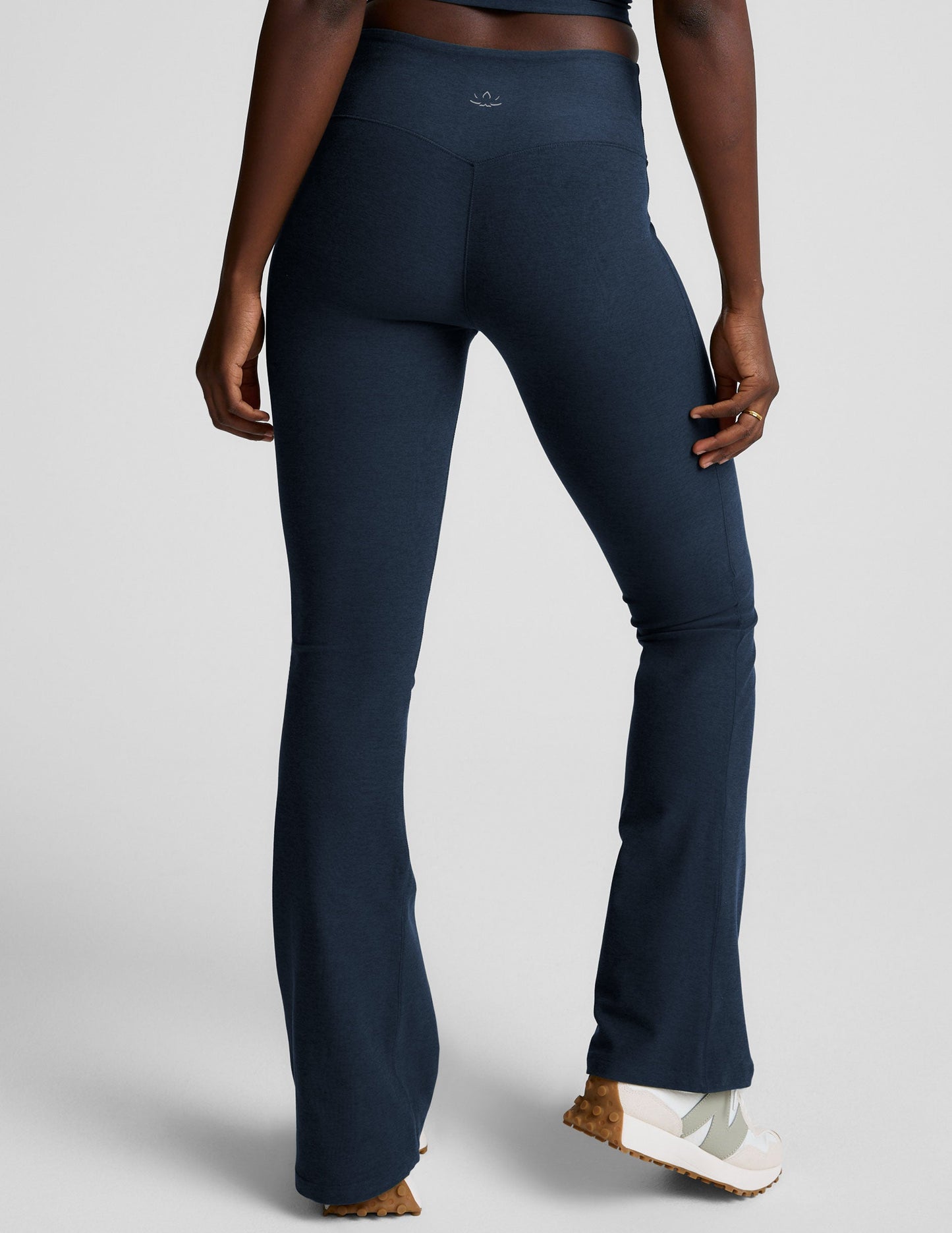 Rear view of navy Spacedye Mid-Rise Bootcut Pant with a snug fit, flared legs, and logo on the waistband.