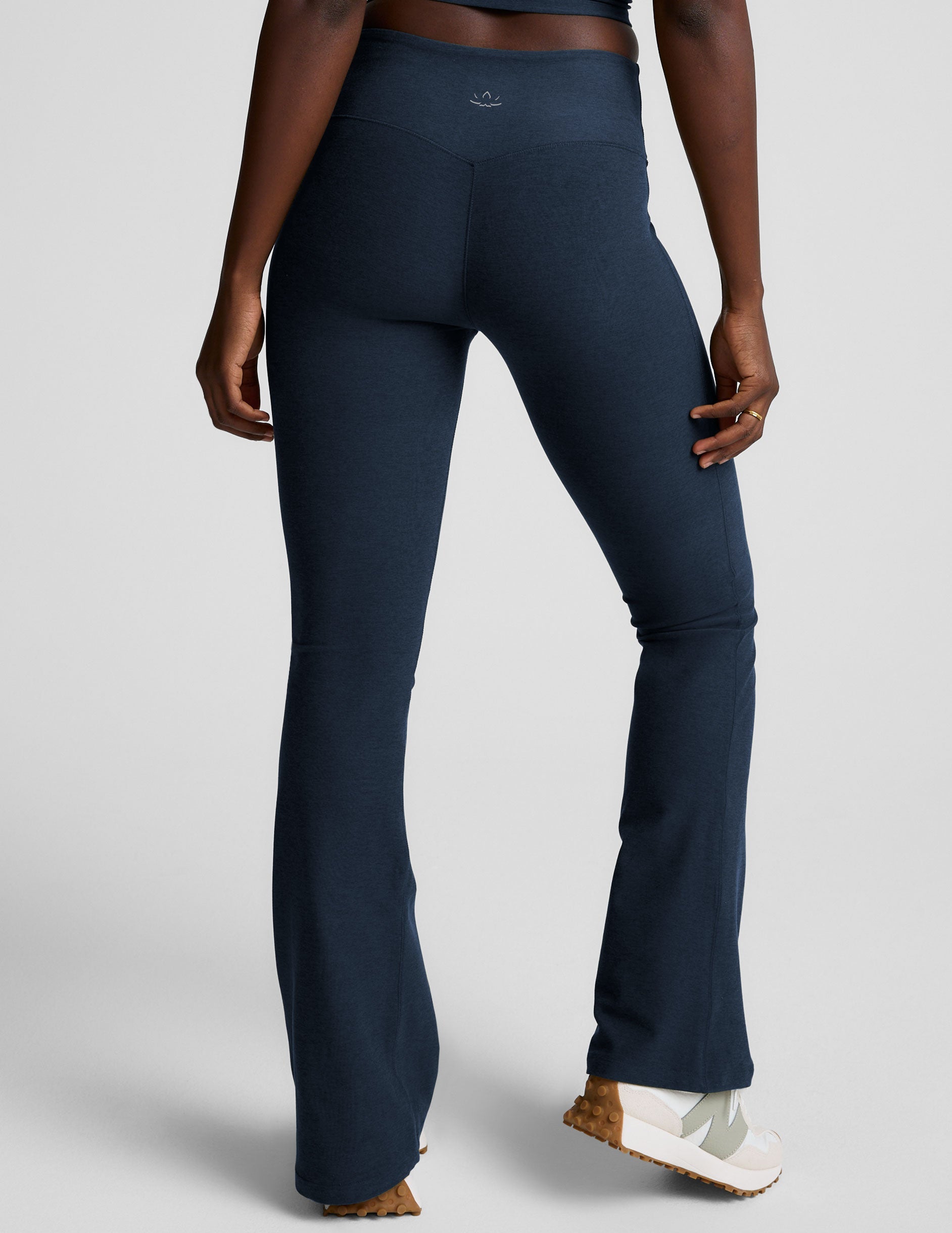 Rear view of navy Spacedye Mid-Rise Bootcut Pant with a snug fit, flared legs, and logo on the waistband.